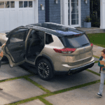 A tan 2026 Nissan Rogue parked on a driveway