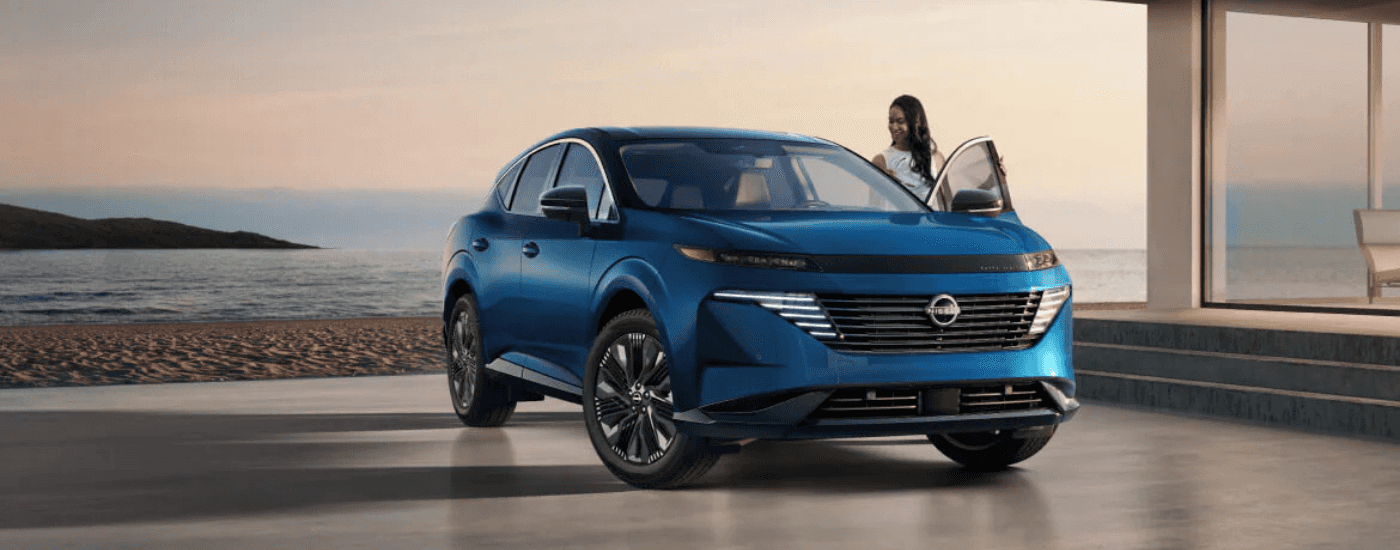 A person gets into a blue 2026 Nissan Murano