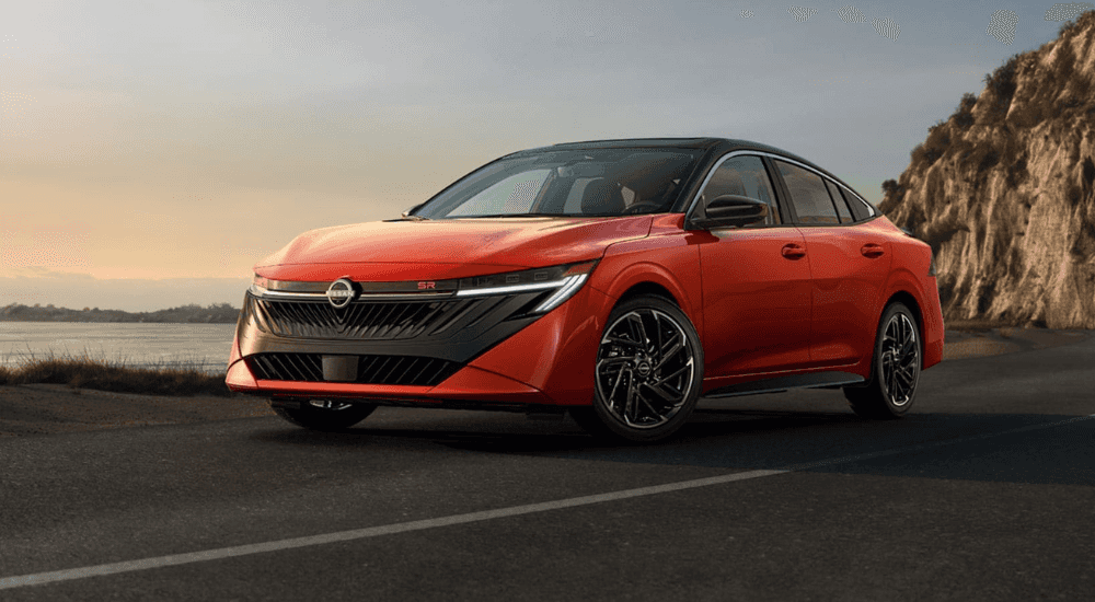 A red 2026 Nissan Sentra driving on a highway