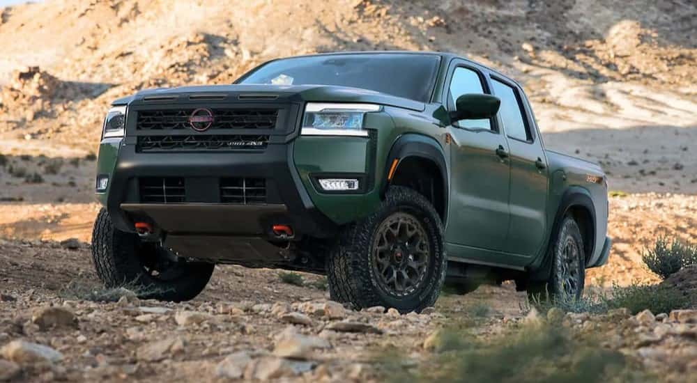 A green 2026 Nissan Frontier PRO-4X R parked off-road.