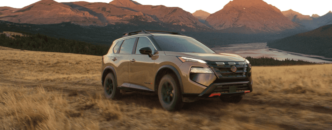 Tan 2026 Nissan Rogue Rock Creek Edition on a trail
