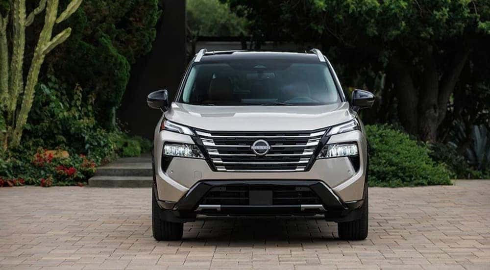 A silver 2026 Nissan Rogue parked on a driveway.
