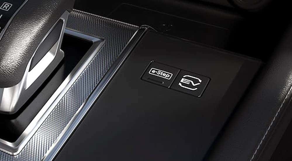 Close-up of an EV button on the center console in a 2026 Nissan Rogue Plug-In Hybrid.
