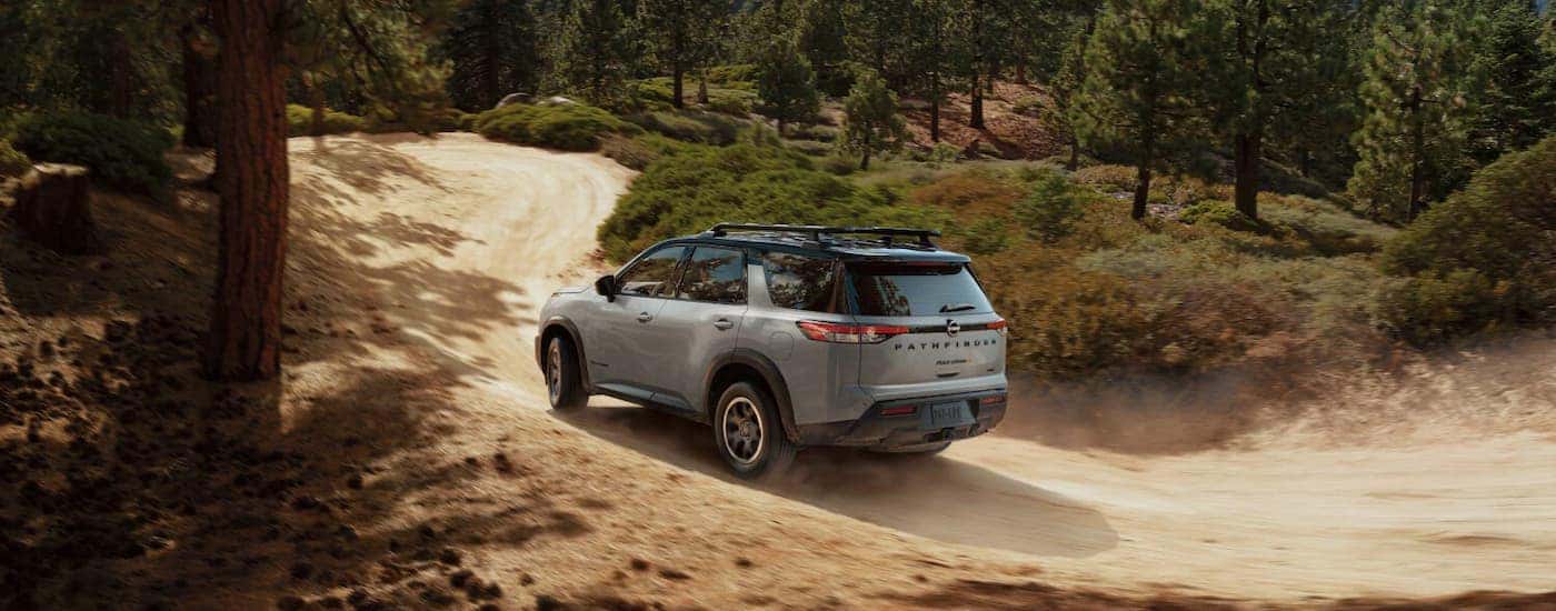 A gray 2025 Nissan Pathfinder off-roading on a dirt trail