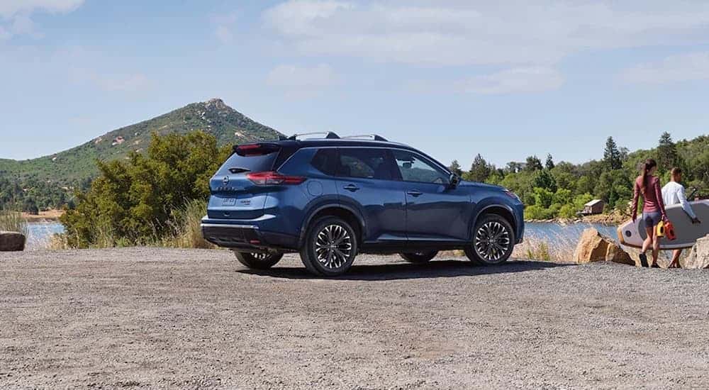 Rear of a dark blue 2026 Nissan Rogue parked off-road.