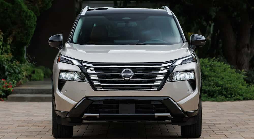 Close-up on the front and grille of a grey 2026 Nissan Rogue.