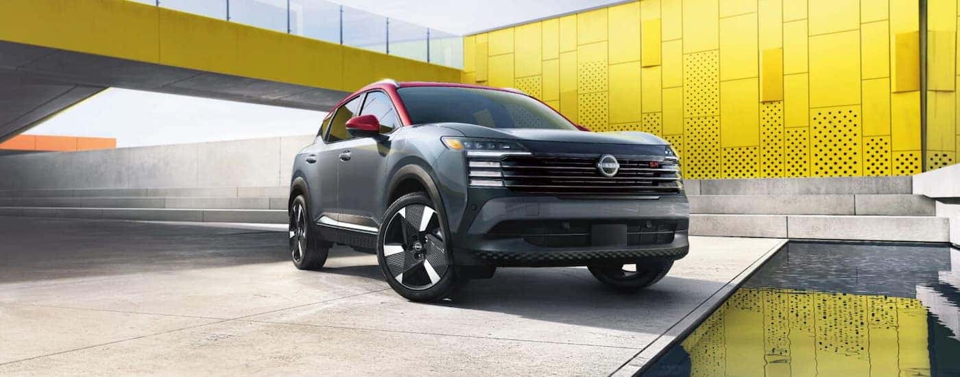 A black and red 2026 Nissan Kicks parked off-road