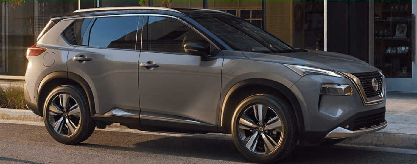 Grey 2021 Nissan Rogue driving through a city