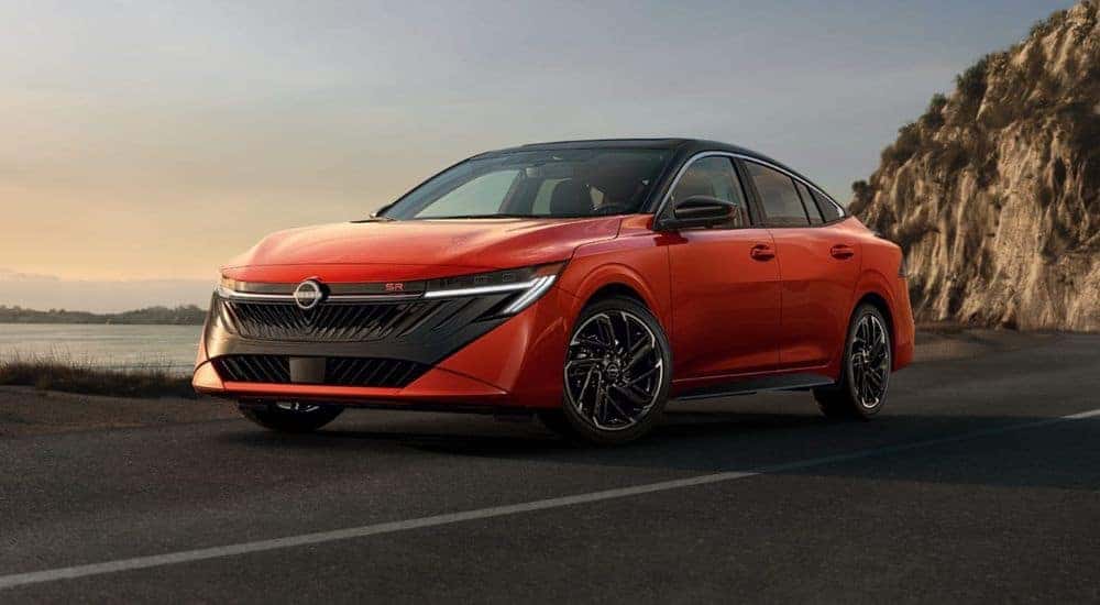 Red 2026 Nissan Sentra driving along the coast