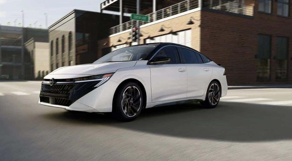 White 2026 Nissan Sentra driving through an intersection