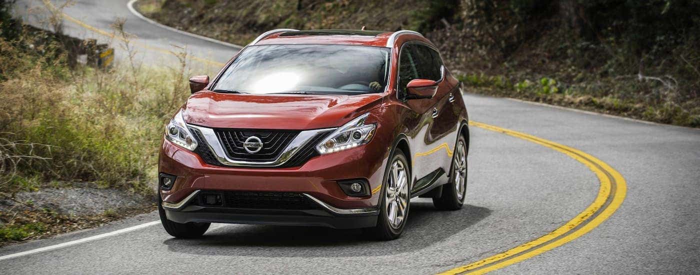 Red 2018 Nissan Murano driving on a winding road