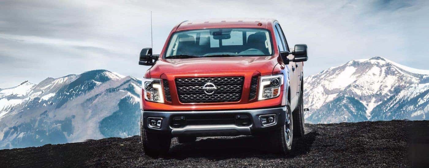 Red 2018 Nissan Titan is shown driving on a mountain path