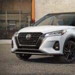 White 2023 Nissan Kicks parked on pavement.