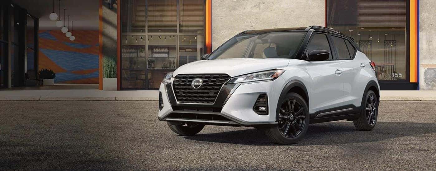 White 2023 Nissan Kicks parked on pavement.