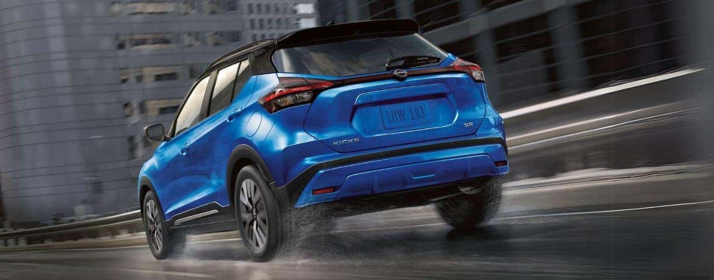 Rear view of a blue 2023 Nissan Kicks.