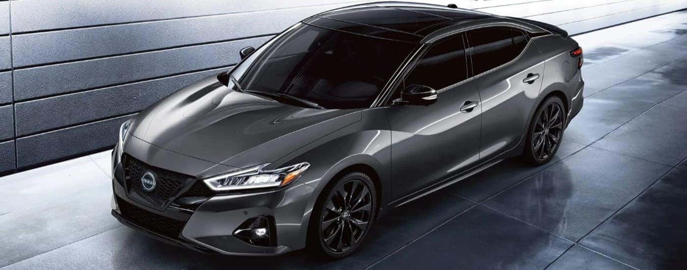 A dark grey 2023 Nissan Maxima SR is shown parked on concrete.
