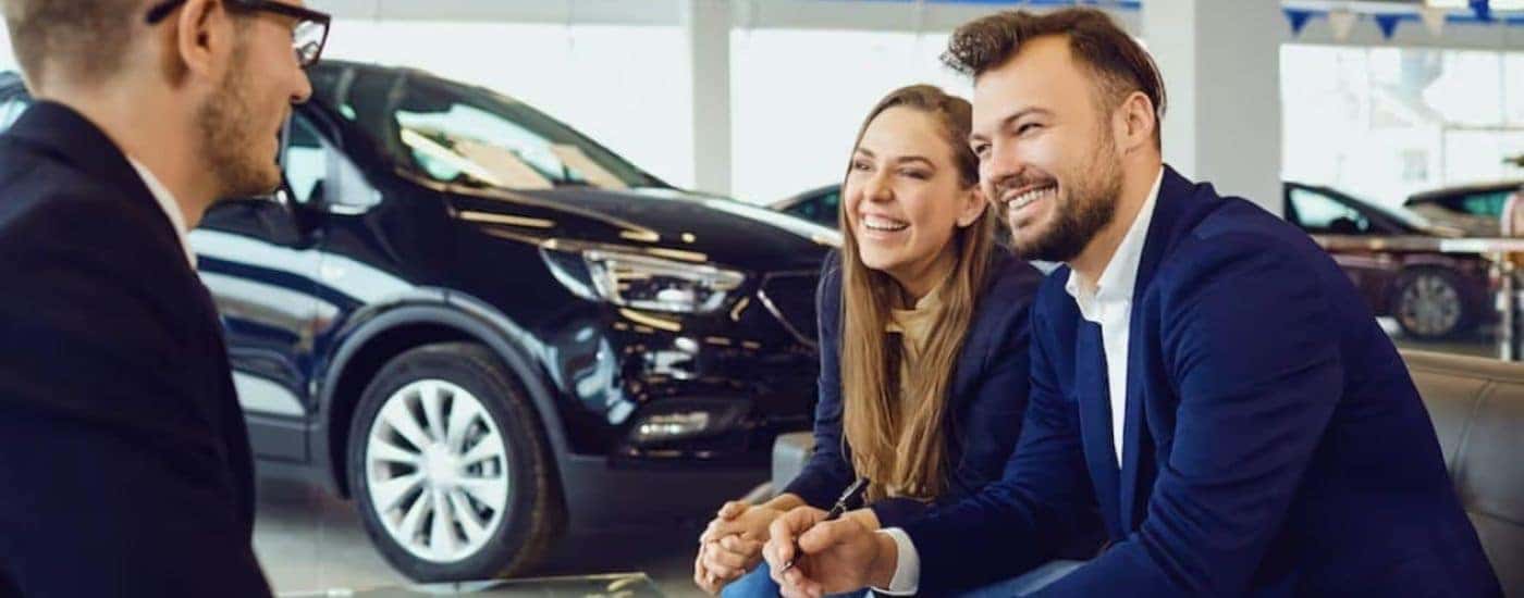A couple is shown talking to a salesperson.
