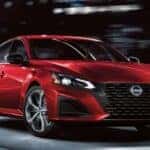A red 2026 Nissan Altima SR shown driving in a city.