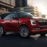 A red 2026 Nissan Armada Platinum Reserve 4WD is shown driving in a city.
