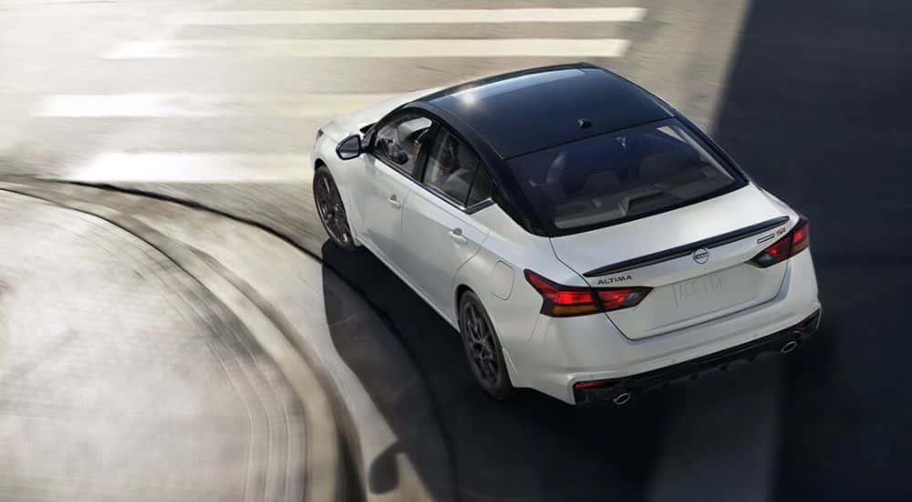 A white 2026 Nissan Altima SR Midnight Edition shown turning a corner.