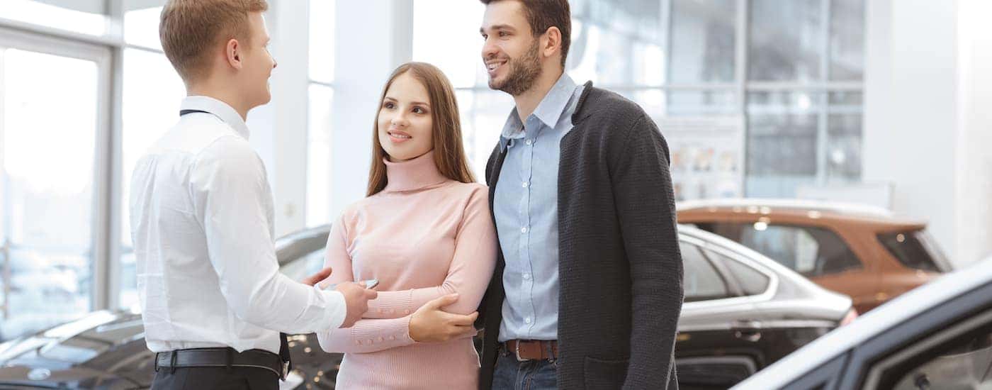 A couple is shown talking to a salesperson