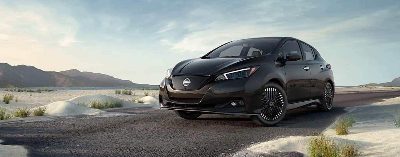 A 2024 Nissan LEAF SV Plus is shown parked near an ocean aftervisiting a Nissan dealer near Monticello.