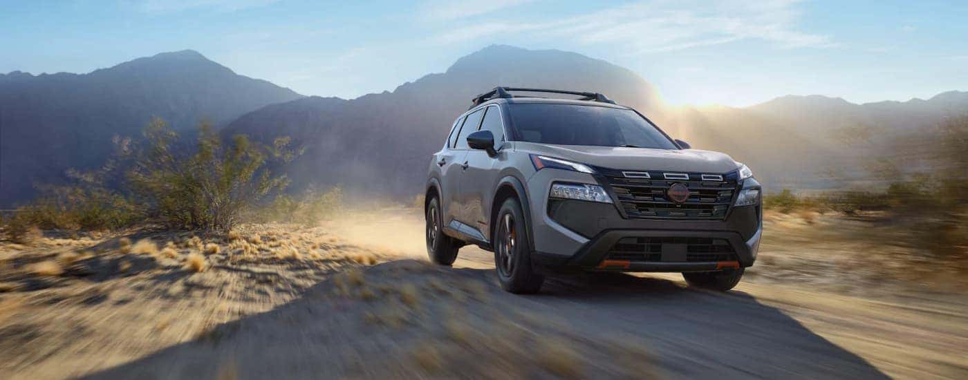 A gray 2026 Nissan Rogue Rock Creek off-roading on a trail