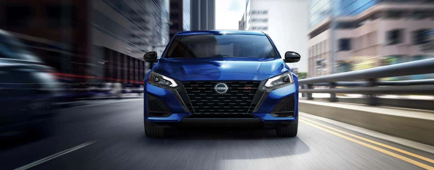 Blue 2023 Nissan Sentra SR driving through a city