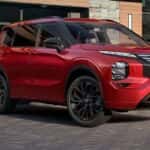 A red 2026 Nissan Rogue Plug-In Hybrid is chrging.