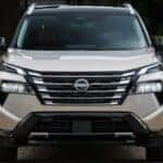 A sand-colored 2026.5 Nissan Rogue Platinum AWD shown parked head-on.