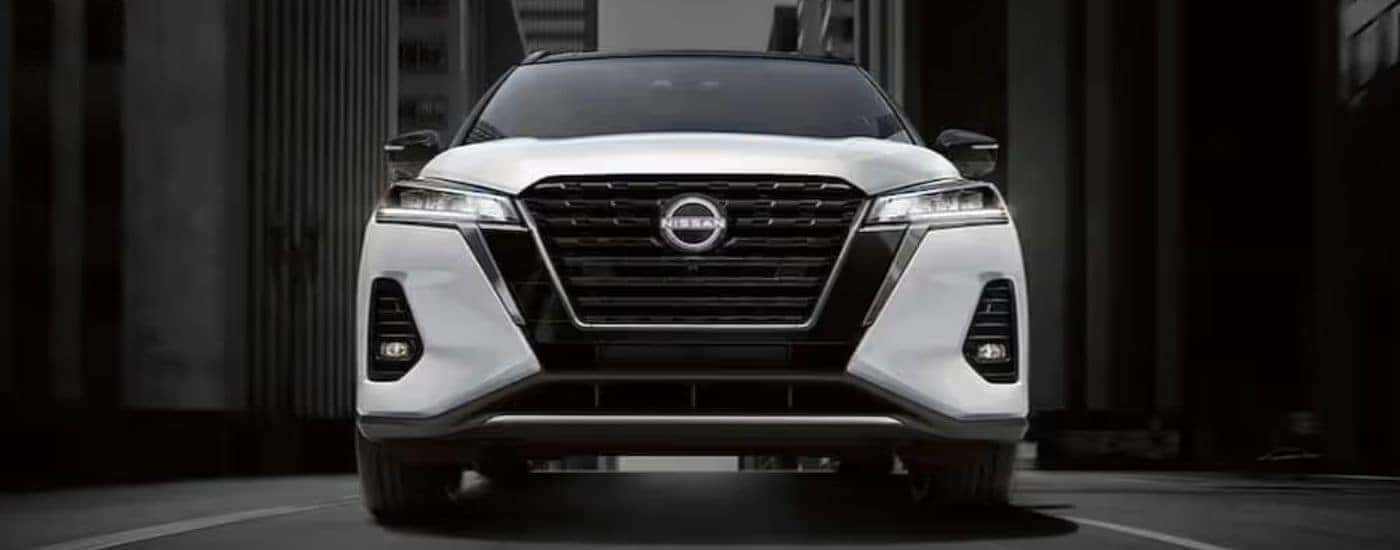 The front end of a white 2024 Nissan Kicks for sale near Urbana is shown.