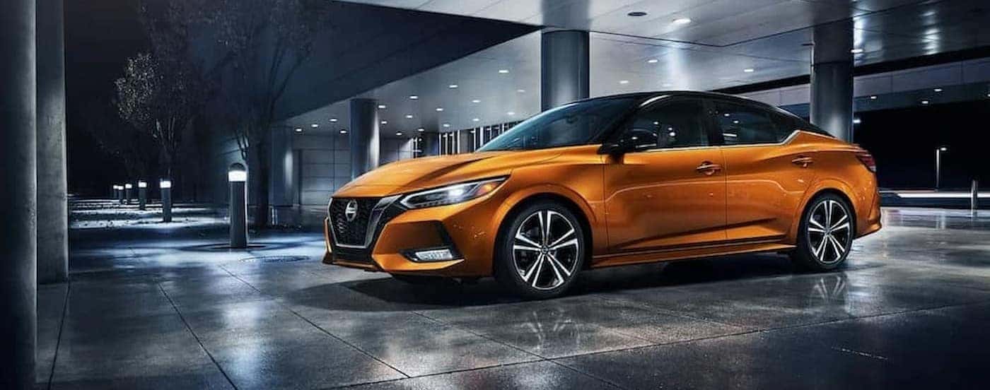 An orange 2023 Nissan Sentra parked at a dealership.