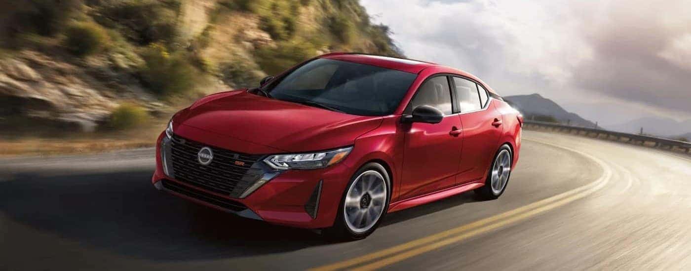 A red 2025 Nissan Sentra SR driving on a highway.