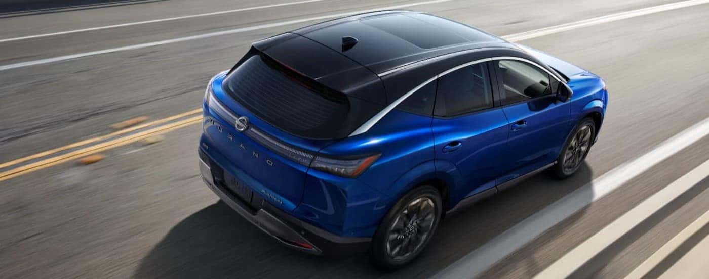 A blue 2026 Nissan Murano driving on a highway.