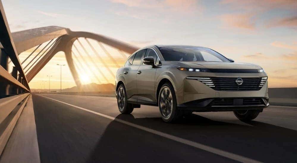 A silver 2026 Nissan Murano driving on a bridge.