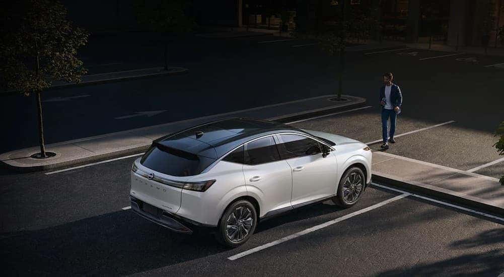 A white 2026 Nissan Murano stopped at a crosswalk.