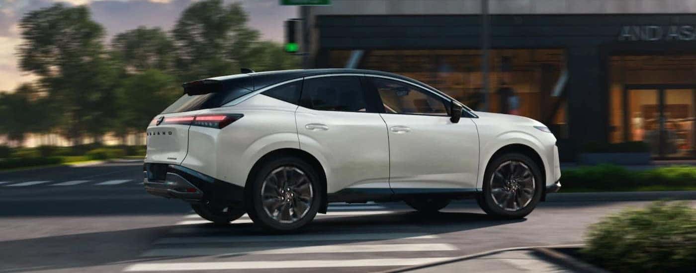 A white 2026 Nissan Murano driving in a city.