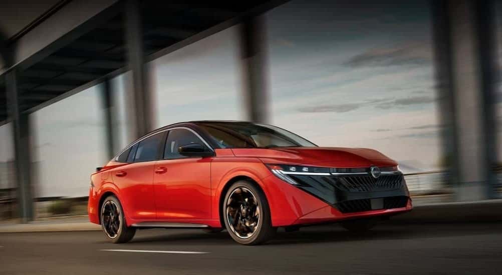 A red 2026 Nissan Sentra driving in a city.