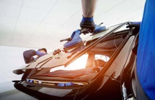 technicians install new rear car window