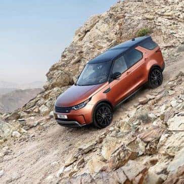 2018 Land Rover Discovery driving down a gravel hill