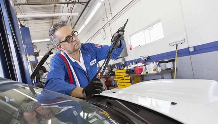 Mechanic Changing Windshield Wipers On A Car