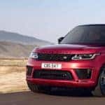 Red Land Rover driving through the mountains