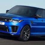 blue Range Rover driving down the highway