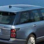 Land Rover cruising down coastal road