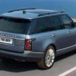 blue 2019 range rover driving on coastal highway