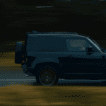 The new Land Rover Defender V8 driving on a highway.