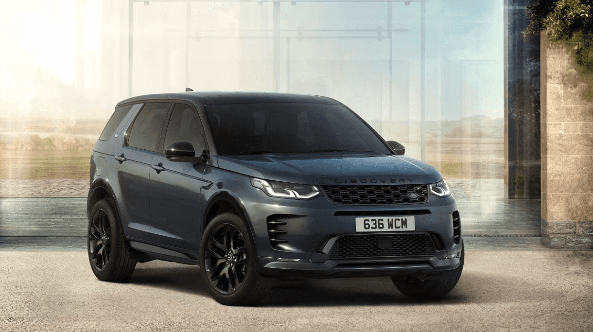 Front and side view of the 2024 Discovery Sport in front of a glass background