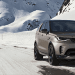 2024 Discovery on a snowy road with mountains in the background