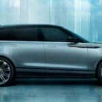 A gray Range Rover Velar in profile in a area that appears to be made from glass.