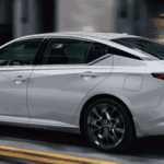 A silver 2024 Nissan Altima in a blurry street scene(2)